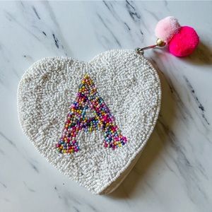 A heart shaped monogram beaded coin purse
